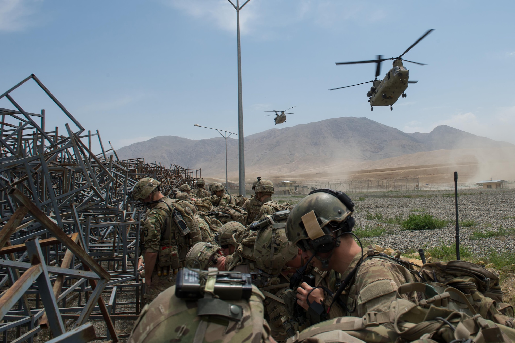 U.S. Army CH-47 Chinook helicopters prepare to land and pick up Air Force Senior Airman Grant Haefke, a Joint Terminal Attack Controller qualified Tactical Air Control Party Airman assigned to the 817th Expeditionary Air Support Operations Squadron, and Soldiers assigned to the 3rd Battalion, 187th Infantry Regiment (Iron Rakkasans), 101st Airborne Division (Air Assault) from an Afghan National Army combat outpost in Afghanistan, June 23, 2015.  Haefke and the Soldiers supported a NATO Resolute Support Train Advise Assist Command-Air mission.  (U.S. Air Force photo by Tech. Sgt. Joseph Swafford/Released)