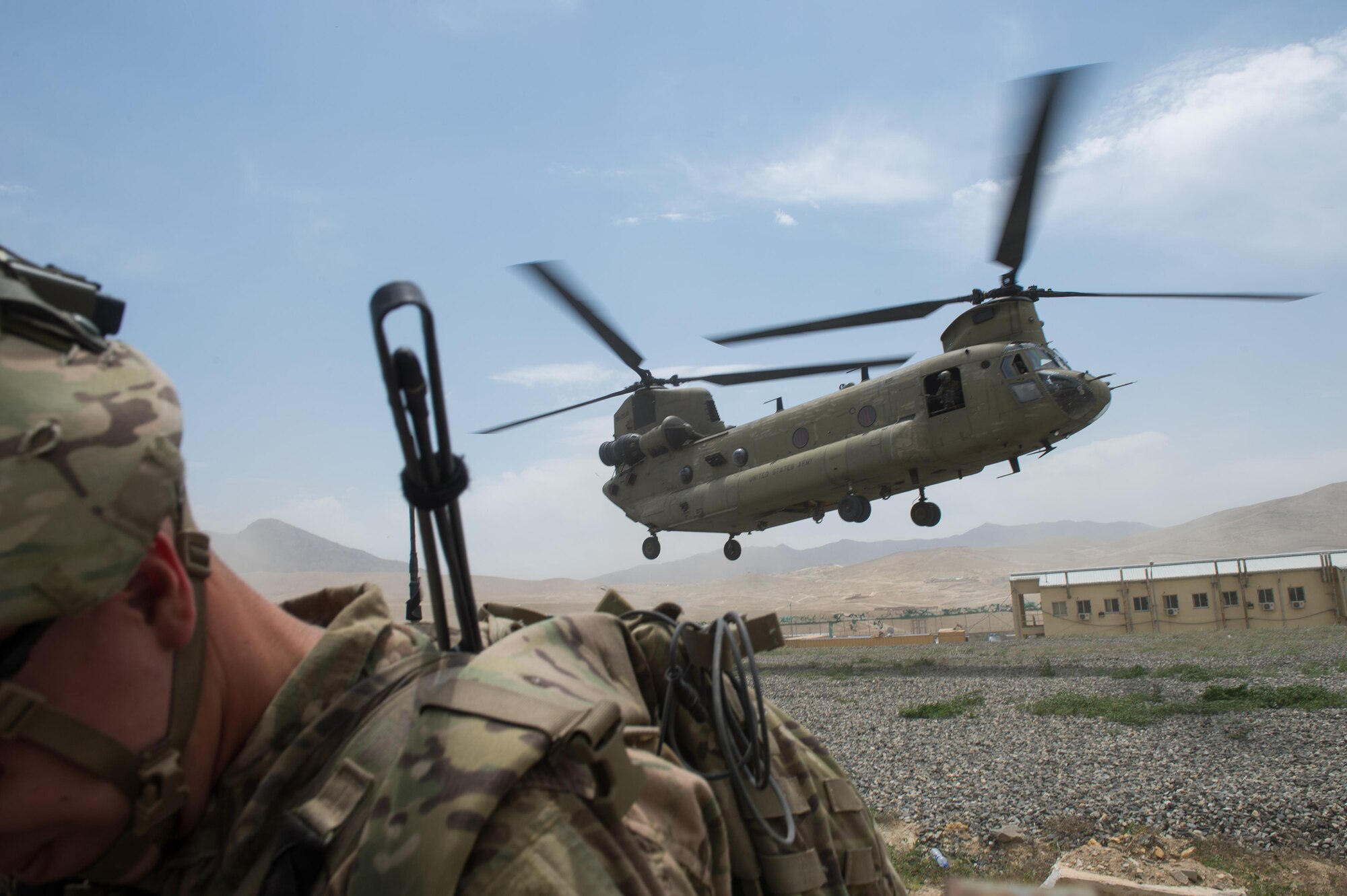 A U.S. Army CH-47 Chinook helicopter prepares to land and pick up Air Force Senior Airman Grant Haefke, a Joint Terminal Attack Controller qualified Tactical Air Control Party Airman assigned to the 817th Expeditionary Air Support Operations Squadron, and Soldiers assigned to the 3rd Battalion, 187th Infantry Regiment (Iron Rakkasans), 101st Airborne Division (Air Assault) from an Afghan National Army combat outpost in Afghanistan, June 23, 2015.  Haefke and the Soldiers supported a NATO Resolute Support Train Advise Assist Command-Air mission.  (U.S. Air Force photo by Tech. Sgt. Joseph Swafford/Released)