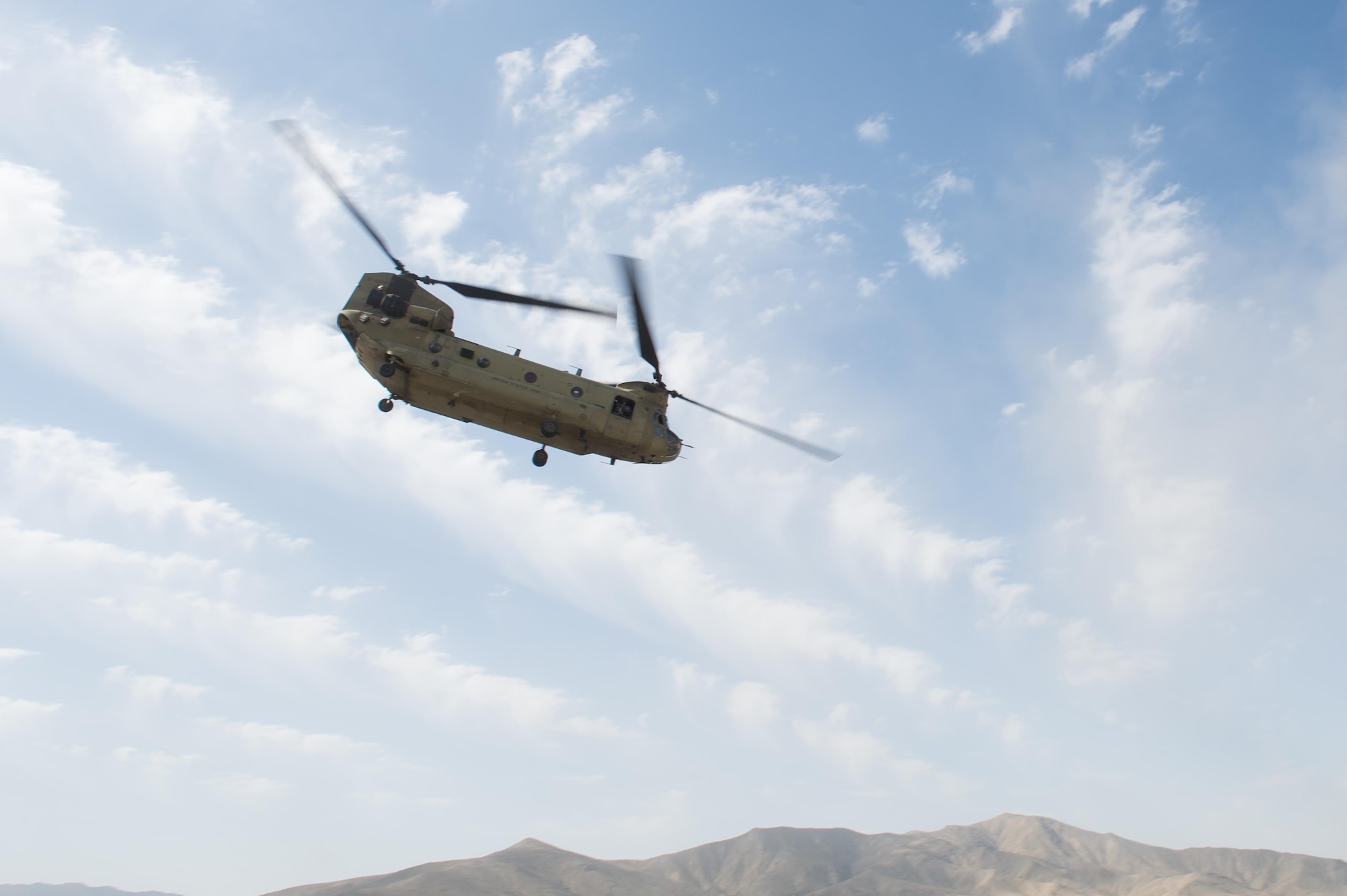 A U.S. Army CH-47 Chinook helicopter takes off after dropping off Senior Airman Grant Haefke, a Joint Terminal Attack Controller qualified Tactical Air Control Party Airman assigned to the 817th Expeditionary Air Support Operations Squadron, and Soldiers assigned to the 3rd Battalion, 187th Infantry Regiment (Iron Rakkasans), 101st Airborne Division (Air Assault) from an Afghan National Army Combat Outpost in Afghanistan, June 23, 2015.  The Chinook supported a NATO Resolute Support Train Advise Assist Command-Air mission.  (U.S. Air Force photo by Tech. Sgt. Joseph Swafford/Released)