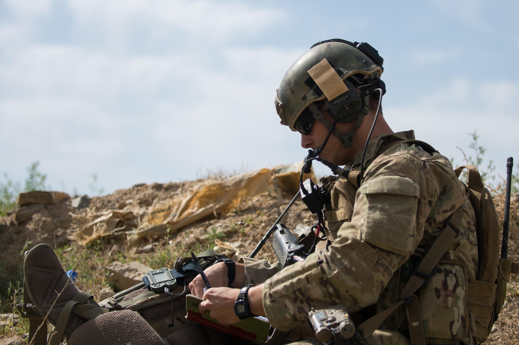 U.S. Air Force Senior Airman Grant Haefke, a Joint Terminal Attack Controller qualified Tactical Air Control Party Airman assigned to the 817th Expeditionary Air Support Operations Squadron, talks to an F-16 Fighting Falcon aircraft pilot during a mission at an Afghan National Army combat outpost in Afghanistan, June 23, 2015.  Haefke was supporting Soldiers with the 3rd Battalion, 187th Infantry Regiment (Iron Rakkasans), 101st Airborne Division (Air Assault) during a NATO Resolute Support Train Advise Assist Command-Air mission.  (U.S. Air Force photo by Tech. Sgt. Joseph Swafford/Released)