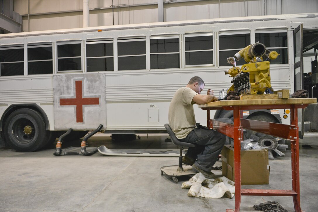 Senior Airman Brent Turner, 379th Expeditionary Logistics Readiness Squadron vehicle maintenance, cleans and inspects several pistons of a passenger bus engine prior to re-installing them June 24, 2015 Al Udeid Air Base, Qatar. Airmen from the 379th ELRS vehicle maintenance shop service over 1,000 government owned vehicles that directly support the mission ranging from small sedans, buses, aircraft and structural support vehicles (U.S. Air Force photo/ Staff Sgt. Alexandre Montes)  