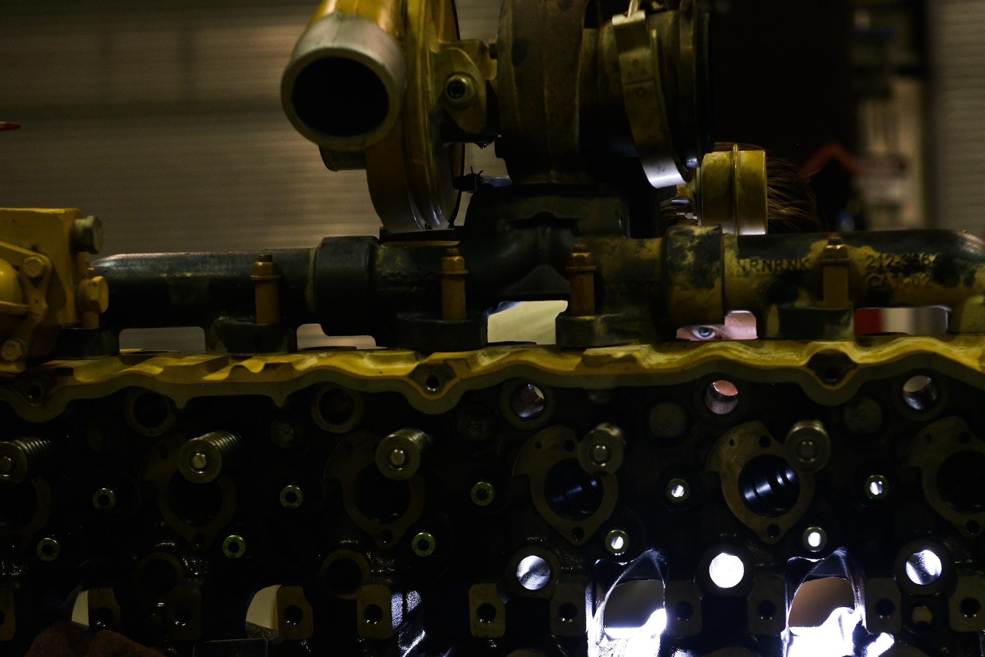 Senior Airman Zachery Horton, 379th Expeditionary Logistics Readiness Squadron vehicle maintenance, inspects valve ports of a passenger bus engine prior to re-installing the pistons June 24, 2015 Al Udeid Air Base, Qatar. Airman from the 379th LRS vehicle maintenance shop service over 1,000 government owned vehicles that directly support the mission ranging from small sedans, buses, aircraft and structural support vehicles (U.S. Air Force photo/ Staff Sgt. Alexandre Montes)  