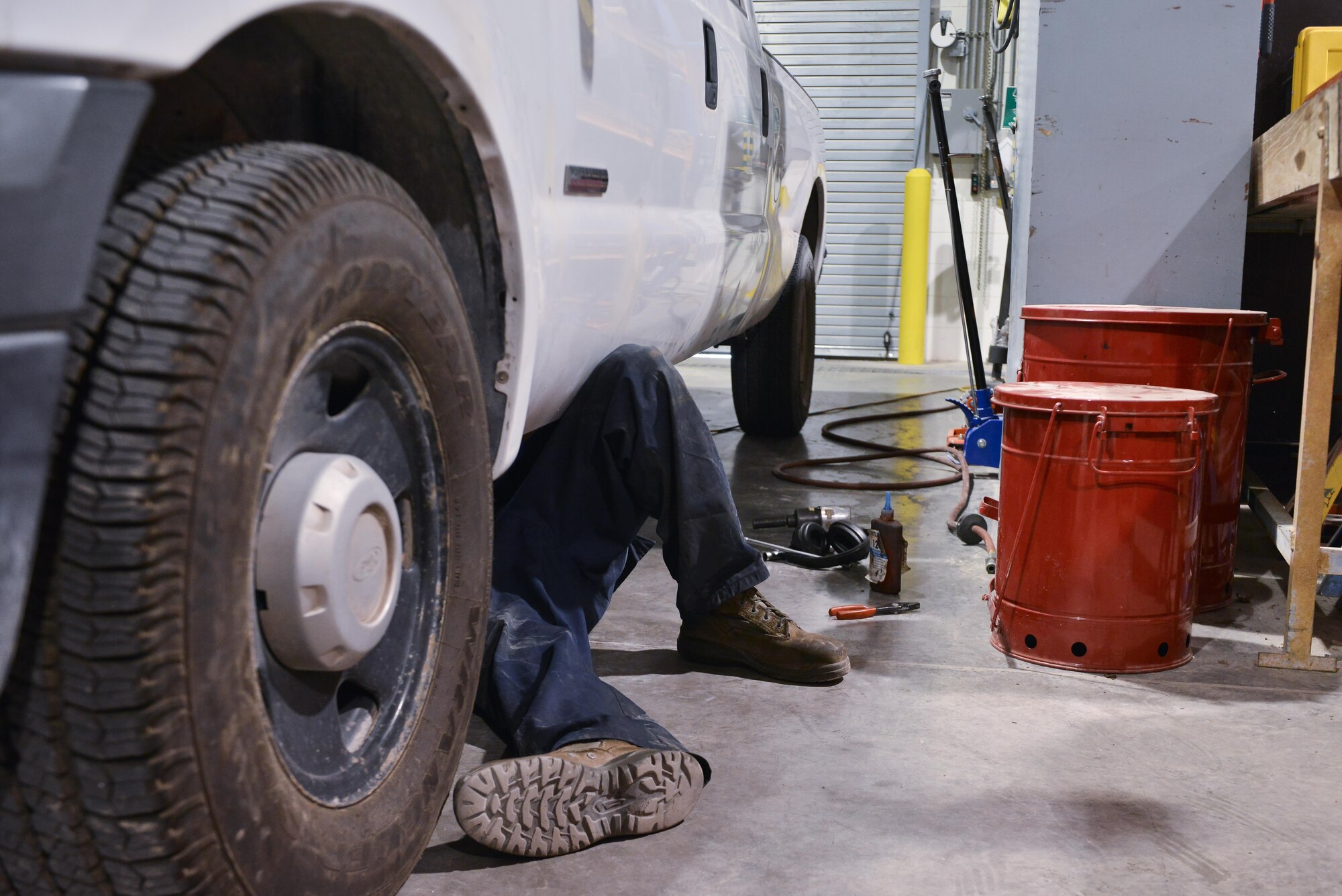 An Airman from the 379th Expeditionary Logistics Readiness Squadron vehicle operations shop completes a vehicle pre-service inspection June 24, 2015 Al Udeid Air Base, Qatar.  Government owned vehicles that are assigned to squadrons go through the scheduled maintenance and repairs at deployed locations. (U.S. Air Force photo/ Staff Sgt. Alexandre Montes)