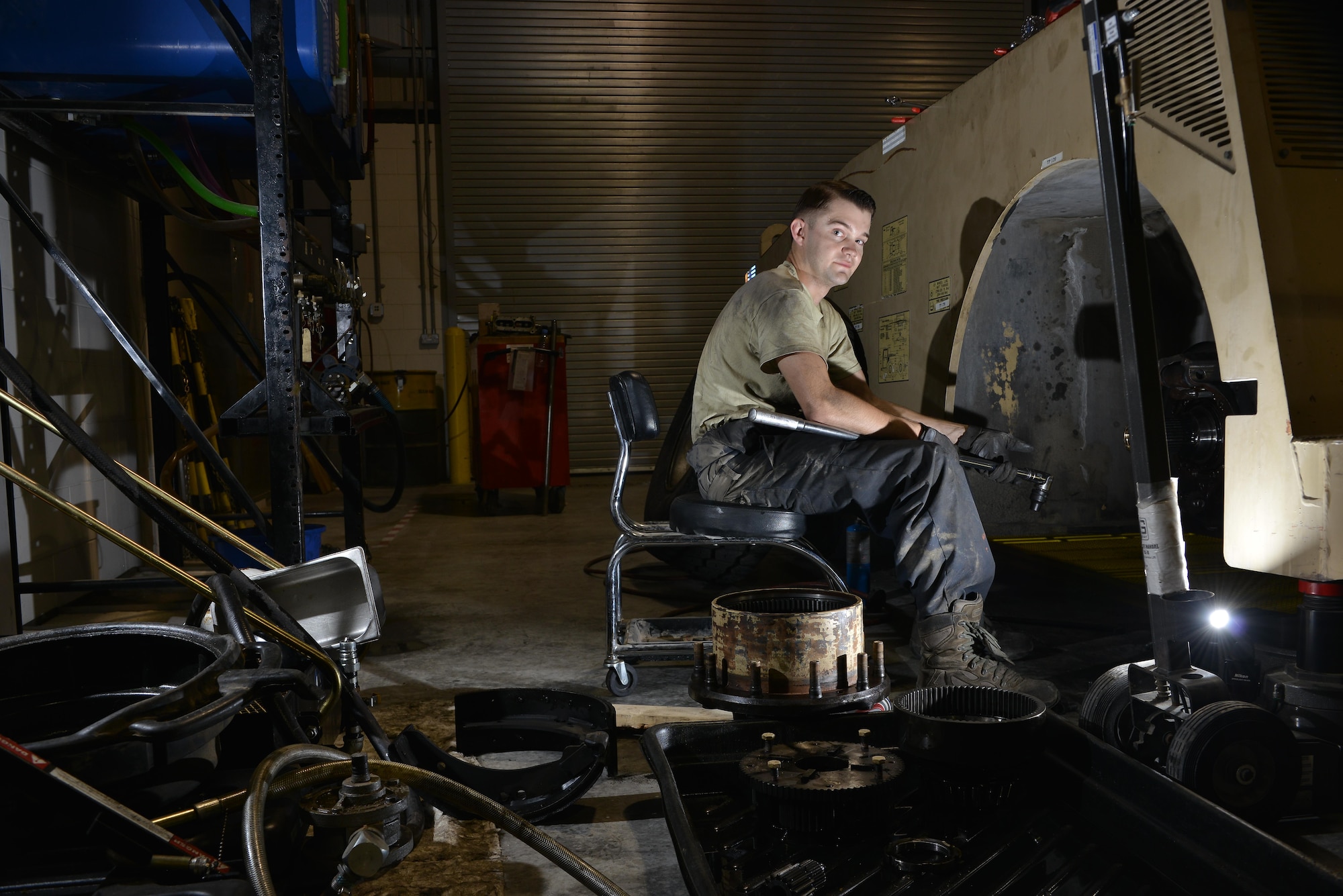Senior Airman Ryan Marney sits by an aircraft towing vehicle during routine maintenance June 24, 2015 Al Udeid Air Base, Qatar. Marney is assigned to the 379th Expeditionary Logistics Readiness Squadron vehicle operations, deployed out of the 20th Logistics Readiness Squadron, Shaw Air Force Base, S.C..(U.S. Air Force photo/ Staff Sgt. Alexandre Montes)  