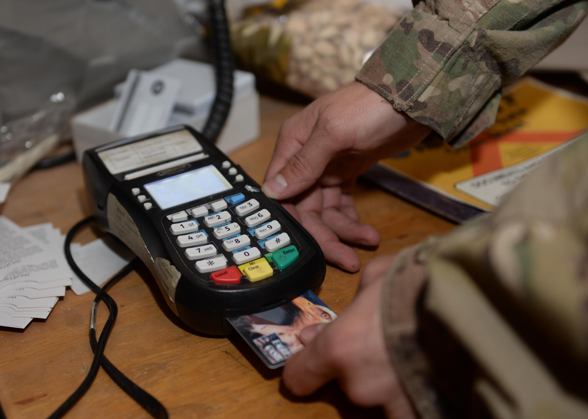 U.S. Air Force Senior Airman Corey Gibson. 455th Air Expeditionary Wing Finance Managements customer service technician activates a customer’s eagle cash card June 24, 2015, at Bagram Airfield, Afghanistan. Gibson is the only finance customer service technician in Afghanistan and ensures all Bagram Active Duty, Reserve and Guard Airmen as well as U.S. civilian members are financially set during their deployment here. (U.S. Air Force photo by Senior Airman Corey Gibson/Released)