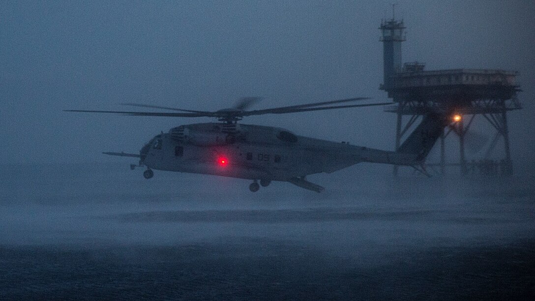 A CH-53E Super Stallion helicopter hovers over the water as Marines from Alpha Company, 2nd Reconnaissance Battalion, 2nd Marine Division, conduct soft-duct insertions out of the back at Joint Expeditionary Base Little Creek-Fort Story, Va., June 16, 2015. The insertion was part of a four-day recon and surveillance mission conducted by the Marines.