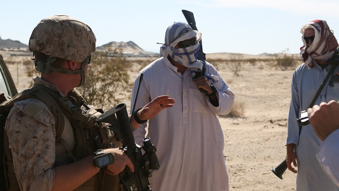 Marines with 1st Explosive Ordnance Disposal Company, 1st Marine Logistics Group, I Marine Expeditionary Force, speak with notional village leaders during a training exercise at Marine Corps Air Ground Combat Center Twentynine Palms, Calif., where they were tasked with disposing of enemy weapons caches and Tactical Recovery of Aircraft and Personnel missions, June 17, 2015. The Marines of 1st EOD Co. are preparing for an upcoming deployment with Special Purpose Marine Air Ground – Crisis Response – Central Command, where they will participate in a fast reaction force role.