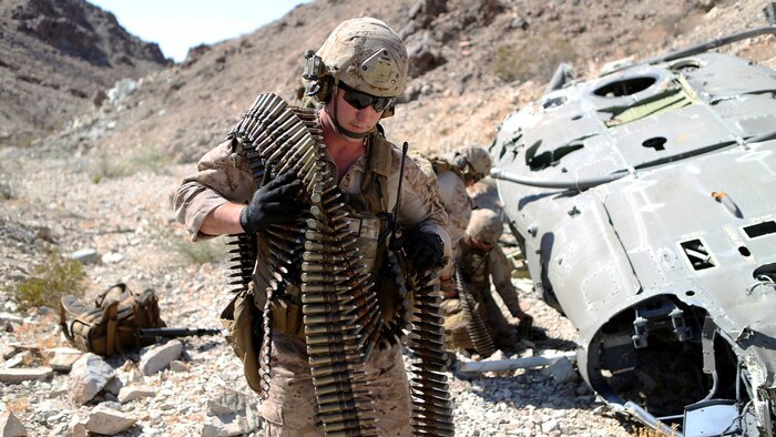 Marines with 1st Explosive Ordnance Disposal Company, 1st Marine Logistics Group, remove ordnance from a downed UH-1 Huey helicopter during a training exercise at Marine Corps Air Ground Combat Center Twentynine Palms, Calif., where they were tasked with sanitizing a wreckage site of any intelligence or ordnance an enemy force could use to their advantage, June 17, 2015. The Marines of 1st EOD Co. are preparing for an upcoming deployment with Special Purpose Marine Air Ground – Crisis Response – Central Command where they will participate in a fast reaction force role.