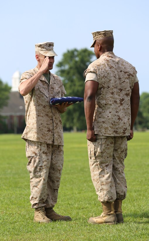 Chief Warrant Officer 5 Nicholas V. Vitale, right, Ground Combat Element Integrated Task Force Gunner, returns a salute to 1st Sgt. John D. Borders, first sergeant of Headquarters and Service Company, GCEITF, after presenting the national flag to Vitale during his retirement ceremony June 18, 2015, at W.P.T. Hill Field, Marine Corps Base Camp Lejeune, North Carolina. The flag was flown over Camp Wilson, Marine Corps Air Ground Combat Center Twentynine Palms, California, April 29, 2015, while Marines were conducting the Marine Corps Operational Test and Evaluation Activity assessment. Vitale retired after serving more than 30 years of service in the Marine Corps. (U.S. Marine Corps photo by Alicia R. Leaders/Released)
