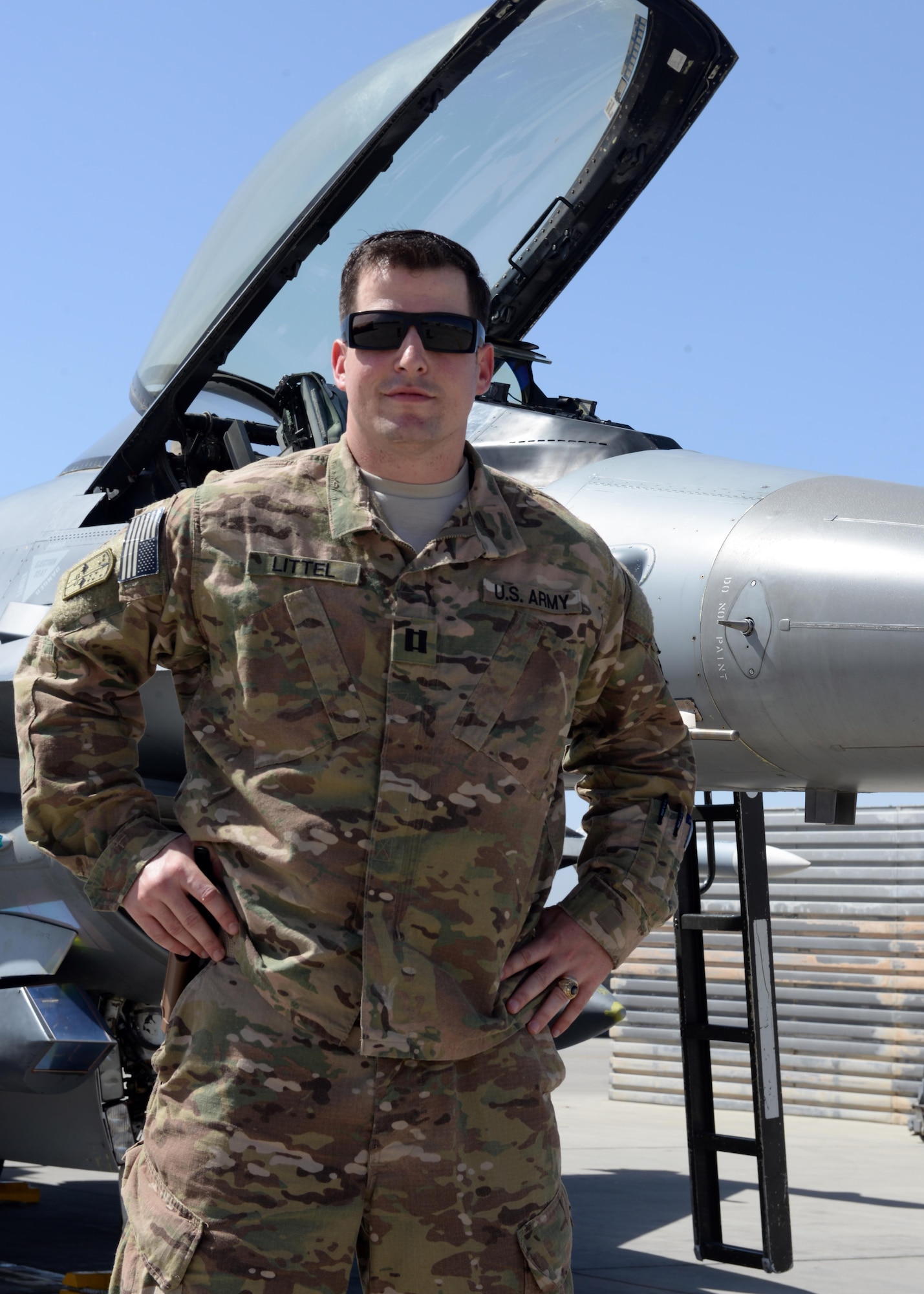 U.S. Army Capt Andrew Littel, 555th Expeditionary Fighter Squadron ground liaison officer, poses in front an F-16 Fighting Falcon aircraft, June 12, 2015, at Bagram Airfield, Afghanistan. As a GLO, Littel briefs pilots on mission parameters as well as provides pilots with a good perspective of what guys on the ground are going through. (U.S. Air Force photo by Senior Airman Cierra Presentado/Released)    