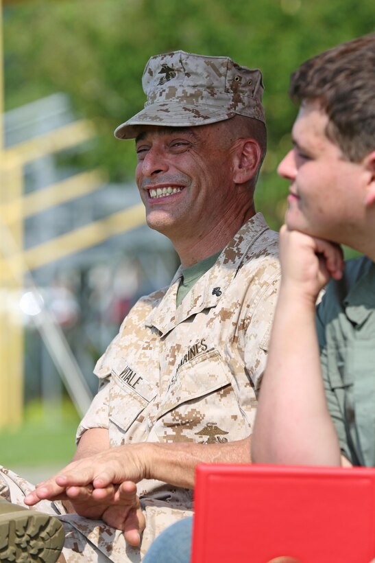 Chief Warrant Officer 5 Nicholas V. Vitale, Ground Combat Element Integrated Task Force Gunner, smiles as he listens to the remarks of Lt. Gen. Robert B. Neller during Vitale’s retirement ceremony June 18, 2015, at W.P.T. Hill Field, Marine Corps Base Camp Lejeune, North Carolina. Neller served as a mentor throughout Vitale’s career, and was the reviewing officer for his ceremony. Vitale retired after serving more than 30 years of service in the Marine Corps. (U.S. Marine Corps photo by Alicia R. Leaders/Released)