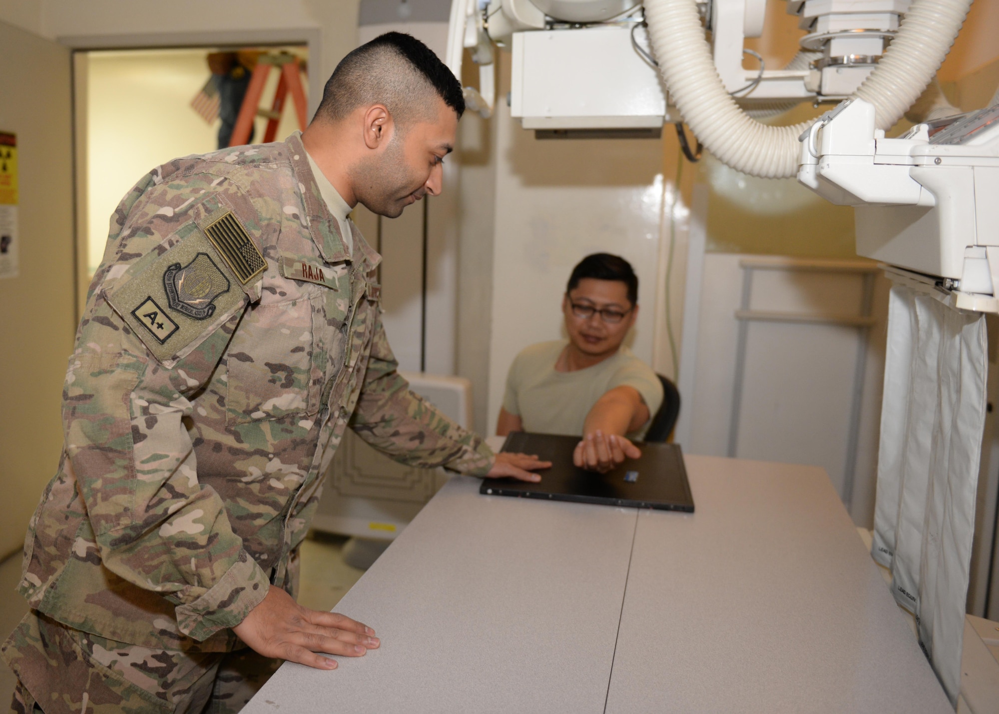 U.S. Air Force Staff Sgt. Asam Raja, 455th Medical Operations Squadron diagnostic imagery technician, provides x-ray support to a patient June 10, 2015, at Bagram Airfield, Afghanistan. Raja is part of the “1000s of Hands” of 455th AEW Airmen who are critical to the wing’s mission to generate and sustain airpower on the combat frontier of Afghanistan for NATO’s Resolute Support mission and Operation Freedom’s Sentinel. The “1000s of Hands” project highlights Vulture Airmen who have a hand in delivering a blanket of steel, technology and courage to protect the force in the field and support Afghan National Defense and Security Forces.
(U.S. Air Force photo by Senior Airman Cierra Presentado/Released)
