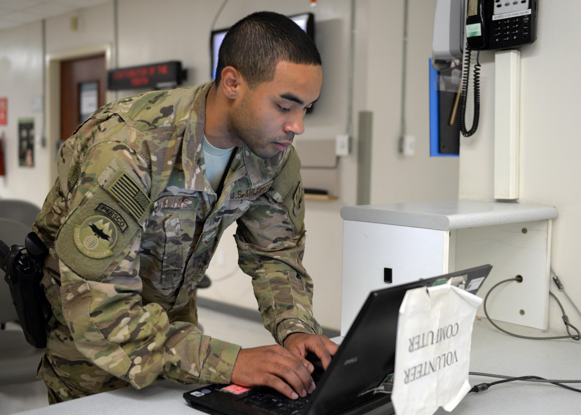 U.S. Air Force Airman 1st Class Torrey Jenkins, 455th Expeditionary Force Support Squadron PERSCO sustainment representative, logs his volunteer hours after completing a shift at the Craig Joint Theater Hospital June 10, 2015, at Bagram Airfield Afghanistan. Jenkins is a member of the hospital volunteer program that allows military and civilians to help around different sections of the hospital throughout their deployment. (U.S. Air Force photo by Senior Airman Cierra Presentado/Released)