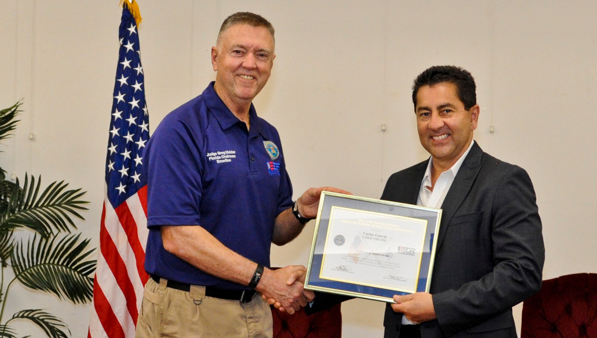 Florida Employer Support of the Guard and Reserve Chairman Emeritus, Judge Gregory Holder, presents Carlos Garcia the Patriot award June 7th, 2015, at MacDill Air Force Base. Garcia was nominated by an employee of his, Senior Master Sgt. Nathaniel Greenwich, who wanted to show his appreciation to his employer at U.S. Southern Command in south Florida. The Patriot Award is awarded to employers who go above and beyond to support the National Guard or Reserve military service of their employees. (U.S. Air Force Photo by Staff Sgt. Adam C. Borgman)
