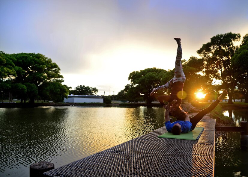 U.S. Air Force Capt. Rachel Schaefer, 27th Special Operations Wing assistant to the Director of Staff, implements trust, concentration and constant communication during a self-taught acro-yoga pose June 14, 2015 at Hillcrest Park in Clovis, N.M. Schaefer and her husband have focused on physically challenging themselves by learning something new to do together. (U.S. Air Force photo/Senior Airman Chip Slack) 