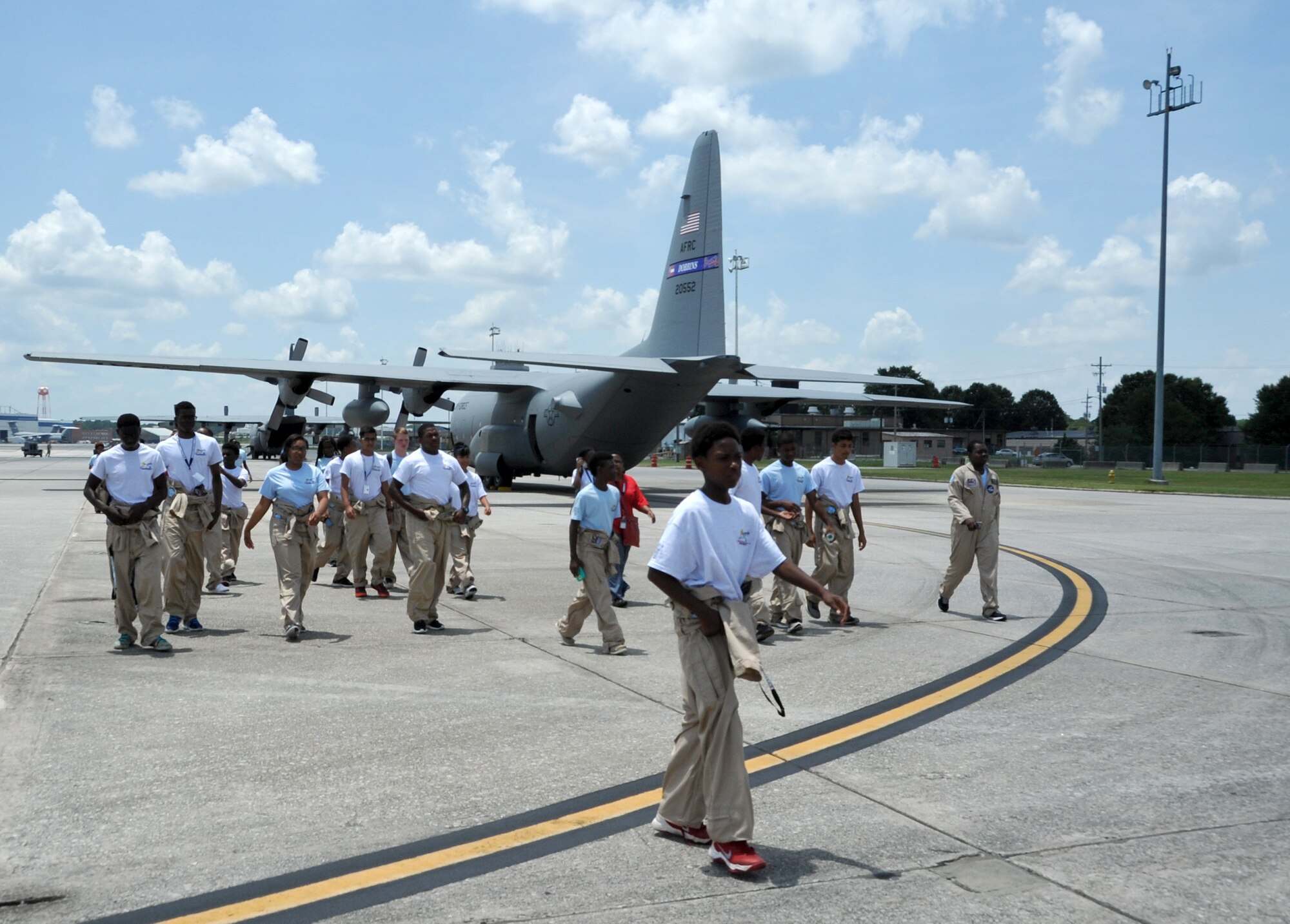 Tuskegee Airmen Aviation Career Training Cadets walk the flight line in preparation to board a C-130 Hercules at Dobbins Air Reserve Base, Ga. on June 25, 2015.  The tours are part of a vocation preparation program designed to give youth an opportunity to explore career fields in aviation. (U.S. Air Force photo/Tech. Sgt. Karla V. Lehman)