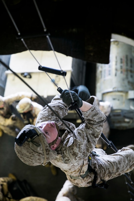 ARABIAN SEA (June 23, 2015) U.S. Marine Lance Cpl. Zane Harmon climbs a caving ladder aboard the USS Essex (LHD 2). Harmon is a member of the 15th Marine Expeditionary Unit’s Maritime Raid Force security element. The security element is made up of Marines from Lima Company, Battalion Landing Team 3rd Battalion, 1st Marine Regiment. These Marines support the MRF by providing extra security and firepower during missions. The 15th MEU is embarked on the Essex Amphibious Ready Group and deployed to maintain regional security in the U.S. 5th Fleet area of operations. (U.S. Marine Corps photo by Cpl. Anna Albrecht/ Released)