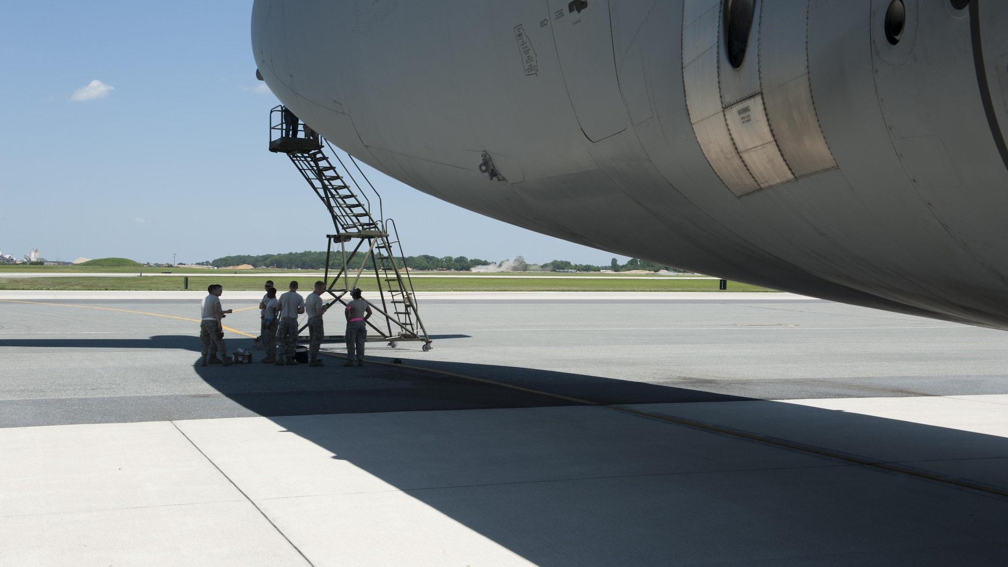 Senior Airman Joseph Carmona and Senior Airman Daniel Soto, both structural maintenance mechanics with the 436th Maintenance Squadron, apply an Air Force Reserve Command stencil to the side of a C-5M Super Galaxy June 22, 2015, at Dover Air Force Base, Del. Carmona and Soto also applied an Air Mobility Command stencil to the aircraft. (U.S. Air Force photo/Airman 1st Class Zachary Cacicia)