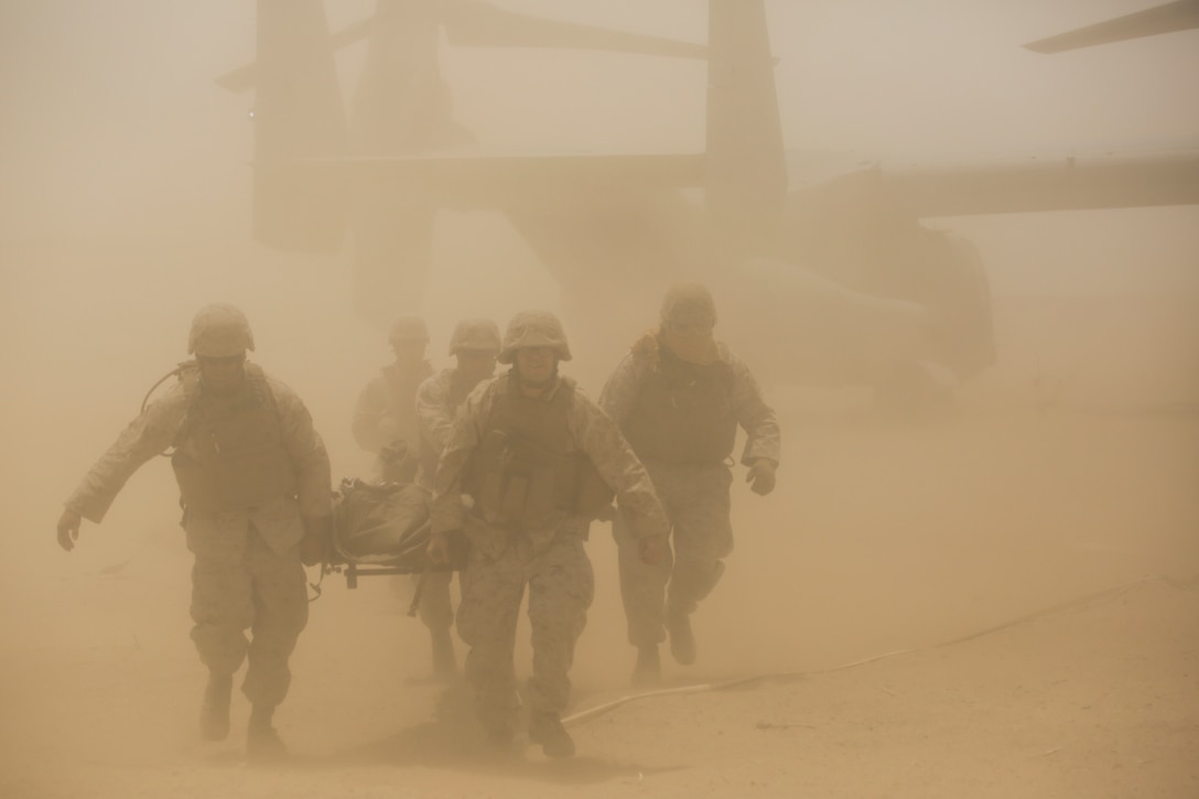 Marines with 4th Medical Battalion, 4th Marine Logistics Group, Marine Forces Reserve, extract a casualty from a aircraft during a mass casualty exercise during 4-15 Integrated Training Exercise aboard Marine Corps Air Ground Combat Center, Twentynine Palms, Calif., June 20, 2015. During the exercise Marines and Sailors worked together to perform a casualty rescue, where victims were extracted or boarded onto an aircraft and transported to a field medical station. (U.S. Marine Corps photo by Cpl. Ian Ferro)