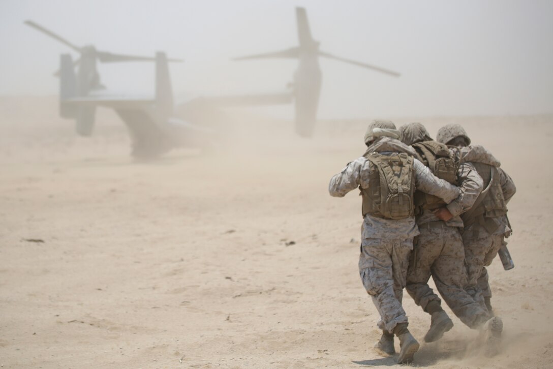 Marines with 4th Medical Battalion, 4th Marine Logistics Group, Marine Forces Reserve, extract a casualty from a aircraft during a mass casualty exercise during 4-15 Integrated Training Exercise aboard Marine Corps Air Ground Combat Center, Twentynine Palms, Calif., June 20, 2015. During the exercise Marines and Sailors worked together to perform a casualty rescue, where victims were extracted or boarded onto an aircraft and transported to a field medical station. (U.S. Marine Corps photo by Cpl. Ian Ferro)