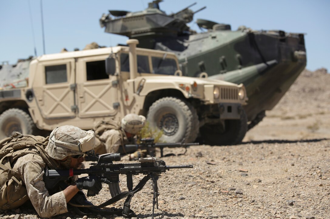 Lance Cpl. John Hernandez, rifleman with Company A, 1st Battalion, 23rd Marine Regiment, 4th Marine Division, Marine Forces Reserve, provides security during a mechanized operations course during Integrated Training Exercise 4-15 aboard Marine Corps Air Ground Combat Center Twentynine Palms, Calif., June 15, 2015. During these exercises, infantry Marines are trained to effectively move in and out of amphibian assault vehicles during combat simulations. ITX allows Reserve Marines to train in realistic environments and conditions, which reinforces maintenance of the highest levels of proficiency and readiness in preparation for worldwide deployment and the ability to work as a Marine Air Ground Task Force. (U.S Marine Corps photo by Cpl. Ian Ferro)