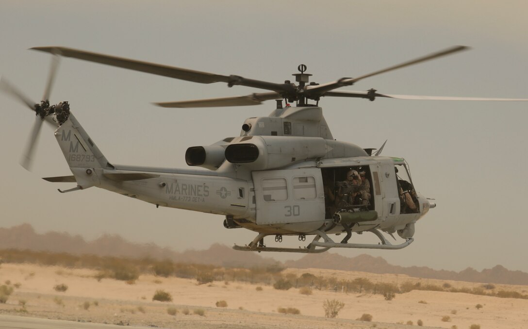 Marines with Helicopter Marine Light Attack Squadron 773, Marine Aircraft Group 49, 4th Marine Air Wing, Marine Forces Reserve, fly aboard the UH1-Y helicopter during Integrated Training Exercise 4-15 on the Camp Wilson flight line aboard Marine Corps Air Ground Combat Center Twentynine Palms, Calif., June 18, 2015. ITX 4-15 gives Marines the opportunity to enhance their cohesion with other units to become more efficient and combat ready. (U.S Marine Corps photo by Cpl. Ian Ferro)