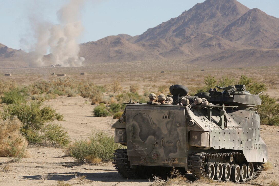 Marines with Company A, 1st Battalion, 23rd Marine Regiment, 4th Marine Division, Marine Forces Reserve experience a simulated enemy explosion while inside an amphibian assault vehicle during a mechanized operations course during Integrated Training Exercise 4-15 aboard Marine Corps Air Ground Combat Center Twentynine Palms, Calif., June 15, 2015. During these exercises, infantry Marines are trained to effectively move in and out of AAVs during combat simulations. ITX allows Reserve Marines to train in realistic environments and conditions, which reinforces maintenance of the highest levels of proficiency and readiness in preparation for worldwide deployment and the ability to work as a Marine Air Ground Task Force. (U.S Marine Corps photo by Cpl. Ian Ferro)