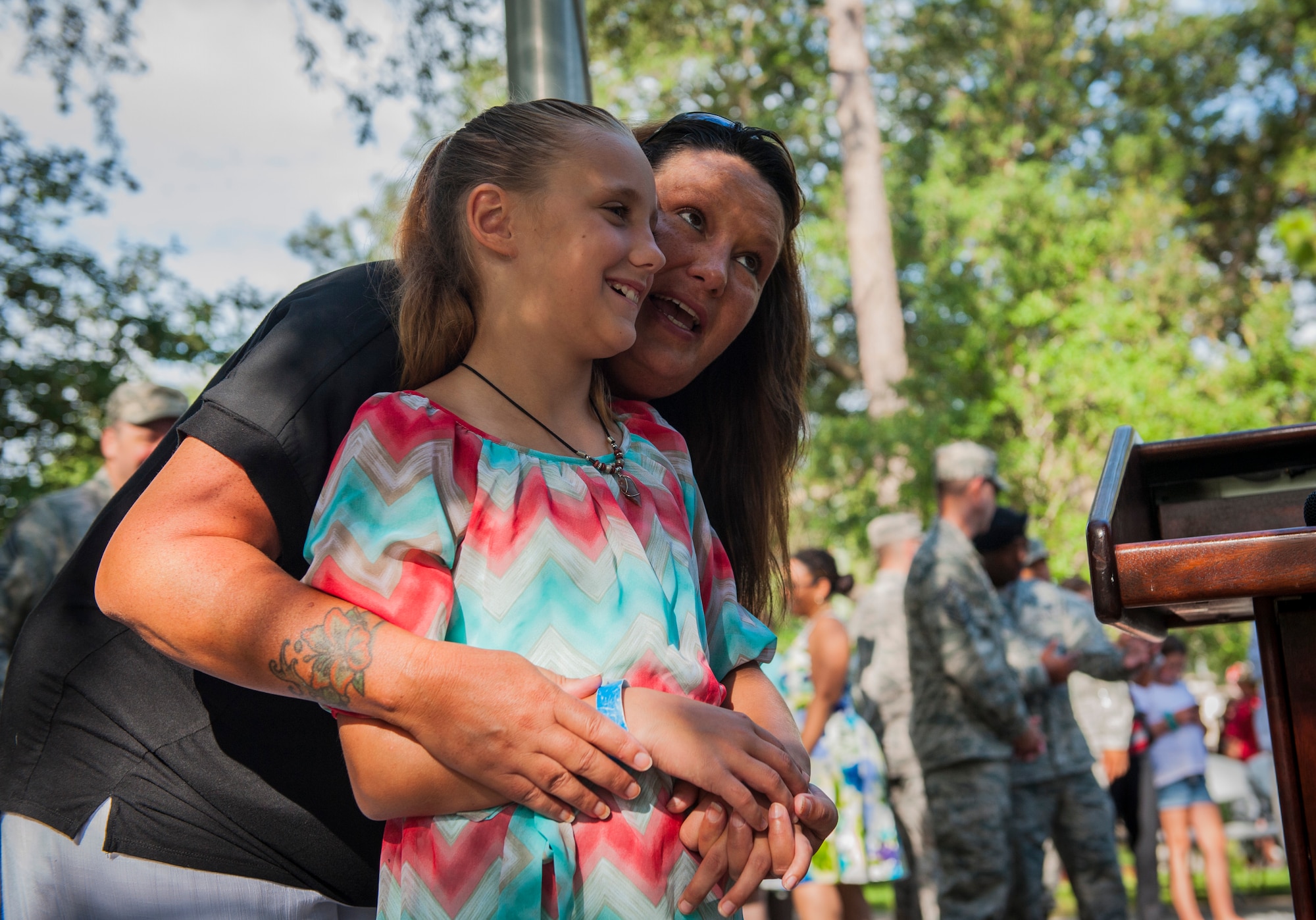 Tracy Bozeman, former 58th Fighter Squadron supply personnel, tells her daughter, Carly, stories about Master Sgt. Kendall Kitson, Jr., 58th FS production superintendent and fallen Nomad, after the 19th anniversary Khobar Tower memorial ceremony, June 25, 2015, on Eglin Air Force Base, Florida. Bozeman, a Nomad for 10 years, spoke highly of Kitson, a flight line supervisor during the deployment, and how he was the best and most patient supervisor she had ever worked with in the Air Force. (U.S. Air Force photo/Staff Sgt. Marleah Robertson)