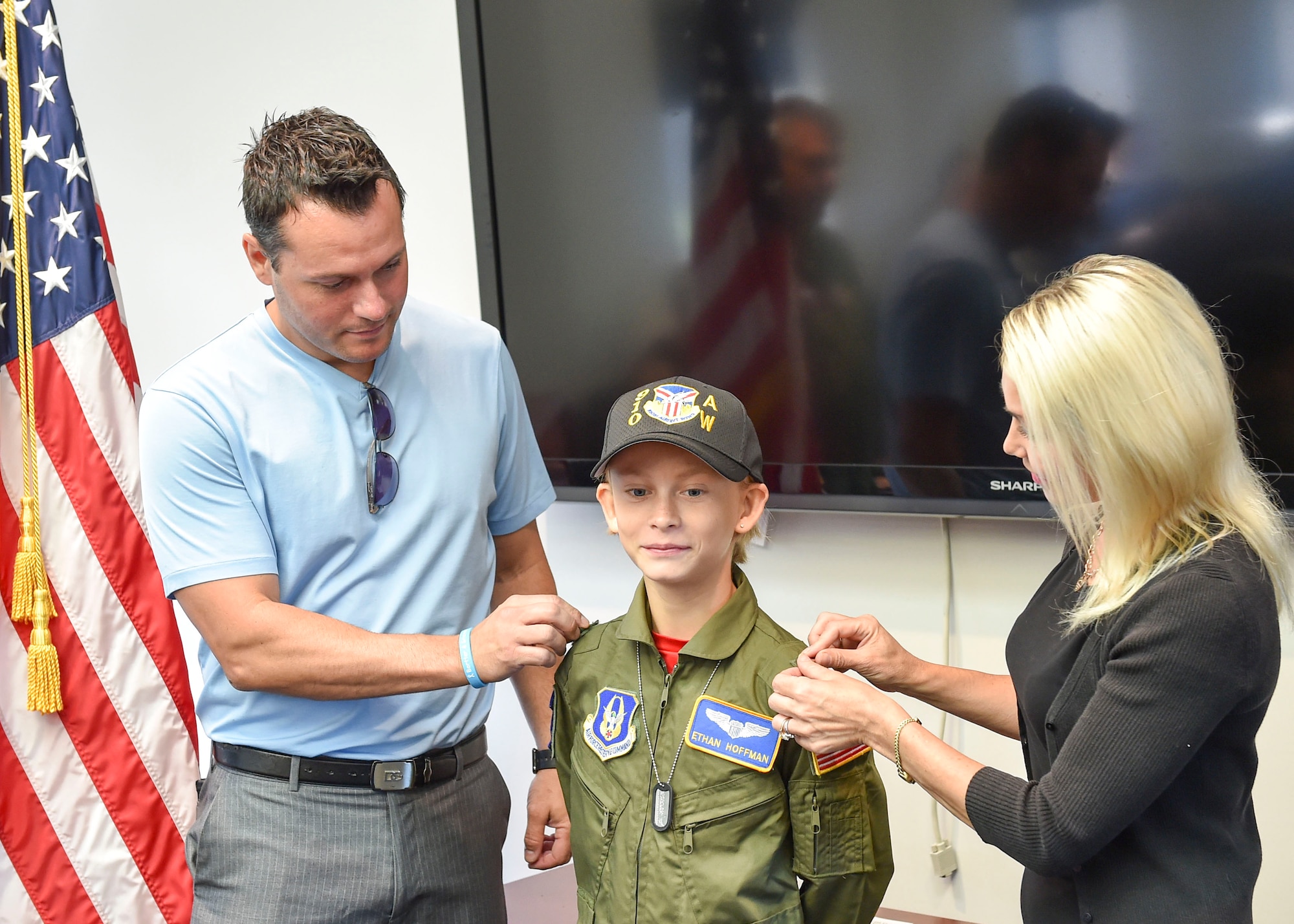 Lilia and Daniel Hoffman, parents of Ethan Hoffman, pin on Ethan’s second lieutenant rank at a commissioning ceremony here Wednesday, June 24. Twelve-year-old Ethan was sworn in as an honorary second lieutenant as he became the 910th Airlift Wing’s 62nd Pilot for a Day, receiving a day of military experiences and mementos. Ethan was selected for the program by Akron Children’s Hospital in Boardman where he is treated for Bartter Syndrome, a rare kidney disease he has had since birth. (U.S. Air Force photo/Eric M. White)