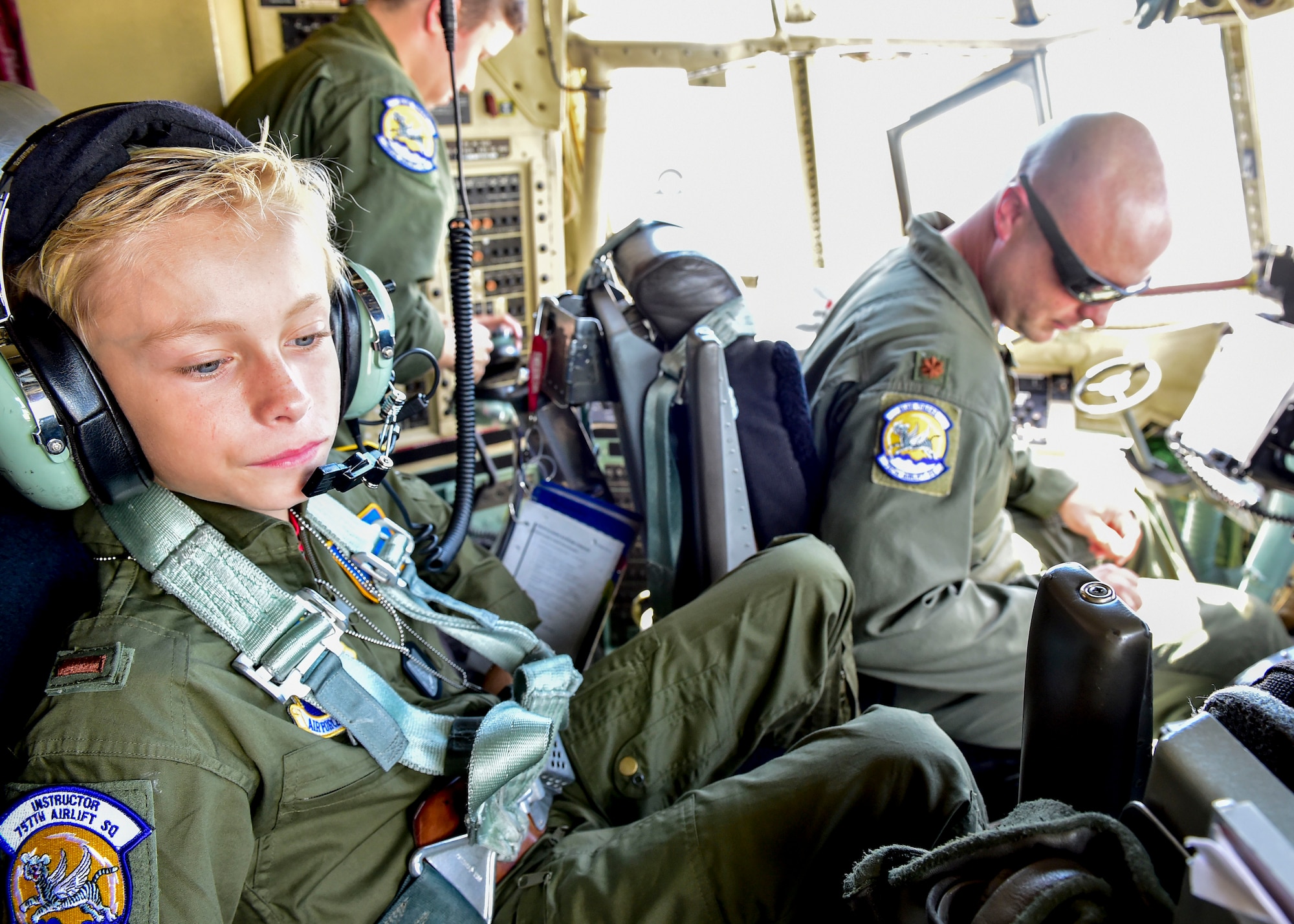 Ethan Hoffman sits in the crew chief seat of a C-130H Hercules aircraft here next to Maj. Brian Hodor, a pilot with the 757th Airlift Squadron, shortly after taxiing down the runway June 24, 2015. Twelve-year-old Ethan was sworn in as an honorary second lieutenant as he became the 910th Airlift Wing’s 62nd Pilot for a Day, receiving a day of military experiences and mementos. Ethan was selected for the program by Akron Children’s Hospital in Boardman where he is treated for Bartter Syndrome, a rare kidney disease he has had since birth. (U.S. Air Force photo/Eric M. White)