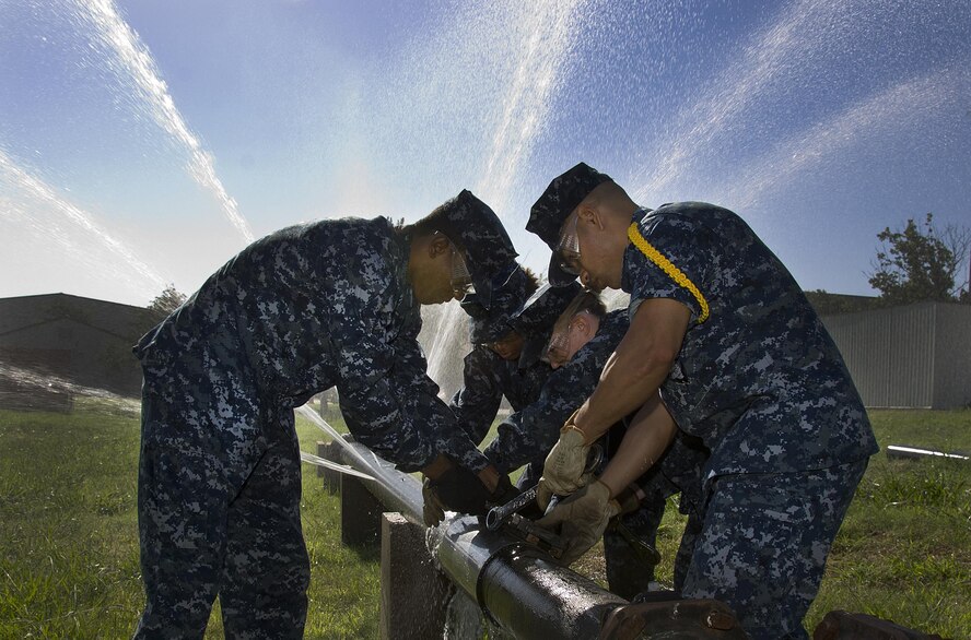 U.S. Navy Sailors assigned to the 366th Training Squadron for training perform emergency repairs to a simulated water main in the Water and Fuel Systems Maintenance Apprentice course at Sheppard Air Force Base, Texas, June 24, 2015. Students in the course learn how to install, inspect, maintain, troubleshoot, modify, and repair potable and waste water systems ensuring they comply with environmental and safety regulations. (U.S. Air Force photo/Danny Webb)
