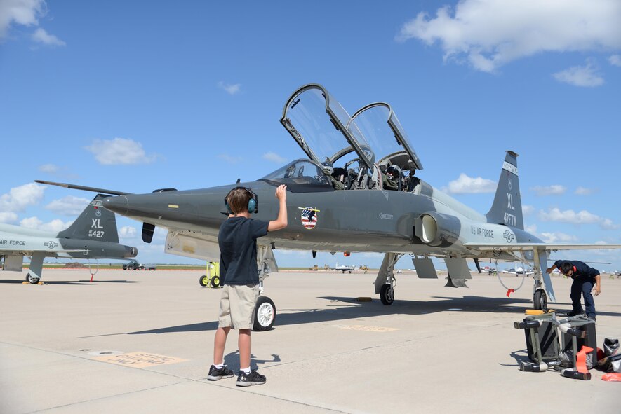 Luke Hastings, son of Col. Brian Hastings, 47th Flying Training Wing commander, marshals his father's aircraft after Col. Hastings' final flight at Laughlin Air Force Base, Texas, June 25, 2015. In preparation for Hasting's change of command ceremony set to occur on Monday, June 29, he completed his "fini flight" with Lt. Col. Joshua Lechowick, 47th Operations Group deputy commander, in the T-38 Talon. (U.S. Air Force photo by Airman 1st Class Brandon May)
