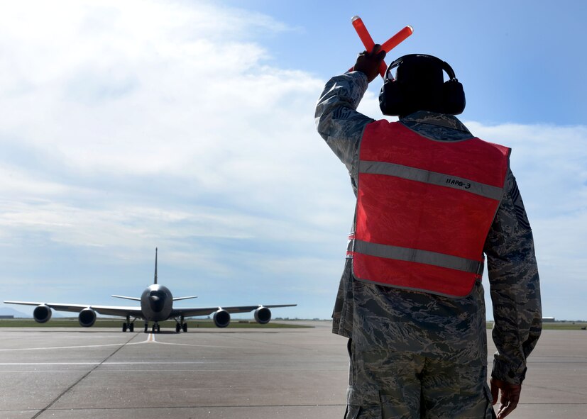 U.S. Air Force Chief Master Sgt. James Powell, 97th Air Mobility Wing command chief, marshals a U.S. Air Force KC-135 Stratotanker, operated by U.S. Air Force Col. Bill Spangenthal, 97th AMW commander, at Altus Air Force Base, Oklahoma, June 18, 2015. Spangenthal has served as the wing commander since June 2013 and will transfer command to U.S. Air Force Col. Todd Hohn who will assume command June 26. (U.S. Air Force photo by Senior Airman Franklin R. Ramos)