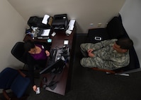 Natalie Sundquist, 1st Special Operations Wing military personnel services human resource assistant, scans a customer’s common access card, June 25, 2015, at Hurlburt Field, Fla. The customer support section provides and updates identification cards, Defense Enrollment Eligibility Reporting System (DEERS), family status, service members' group lifeinsurance, leave web requests, passports/visas and casualty assistance and survivor benefits. (U.S. Air Force photo by Airman 1st Class Ryan Conroy/Released)