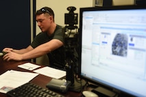 Senior Airman John Simmons, 1st Special Operations Component Maintenance Squadron, uses a fingerprint scanner at the military personnel services to process his identification records, June 25, 2015, at Hurlburt Field, Fla. Hurlburt Field Military Personnel Section serves more than 8,500 active duty members, 32,000 retirees, 1,200 civilian employees and their family members. (U.S. Air Force photo by Airman 1st Class Ryan Conroy/Released)