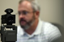 Kelly Schell, 1st Special Operations Force Support Squadron military personnel section human resource assistant, takes a photo of a customer for an identification card, June 25, 2015, at Hurlburt Field, Fla. The Hurlburt Field Military Personnel Section serves more than 8,500 active duty members, 32,000 retirees, 1,200 civilian employees and their family members. (U.S. Air Force photo by Airman 1st Class Ryan Conroy)