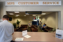 A customer signs into the military personnel service center to be waited on, June 25, 2015, at Hurlburt Field, Fla.  The customer support section provides and updates identification cards, Defense Enrollment Eligibility Reporting System (DEERS), family status, service members' group life insurance, leave web requests, passports/visas and casualty assistance and survivor benefits. (U.S. Air Force photo by Airman 1st Class Ryan Conroy)