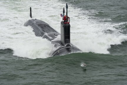 150521-O-ZZ999-110 ATLANTIC OCEAN (May 21, 2015) A dolphin jumps in front of the Virginia-class attack submarine Pre-Commissioning Unit (PCU) John Warner (SSN 785) as the boat conducts sea trials in the Atlantic Ocean. (U.S. Navy photo courtesy of Huntington Ingalls Industries by Chris Oxley/Released)