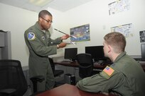1st Lt. Chris Tobiere (left), a T-1 Jayhawk instructor pilot assigned to the 86th Flying Training Squadron at Laughlin AFB, Texas, discusses in-flight safety procedures with Capt. Mark Thompson, 99th Flying Training Squadron safety officer, during the “FAIP-a-Palooza” conference June 26, 2015 at Joint Base San Antonio-Randolph, Texas.  The conference was hosted by the 12th Flying Training Wing to provide First Assignment Instructor Pilots (FAIP) across Air Education and Training Command officer professional development information and stimulate cross-talk amongst FAIP’s. (U.S. Air Force photo/Joel Martinez)