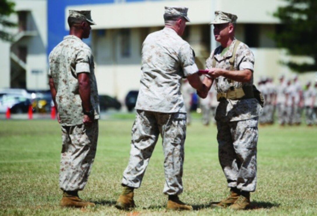 Lt. Col. Robert Maldonado, the outgoing commanding officer of Headquarters battalion, Marine Corps Base Hawaii, receives the meritorious medal from Col. Sean C. Killeen, the commanding officer of Marine Corps Base Hawaii on June 22, 2015 at Dewey Square aboard Marine Corps Base Hawaii. Maldonado relinquished his post to Lt. Col. Michael Brooks, who formerly served as the special actions branch chief of the U.S. Central Command Special Actions Branch in Tampa, Fla. (U.S. Marine Corps photo by Cpl. Adam Korolev)