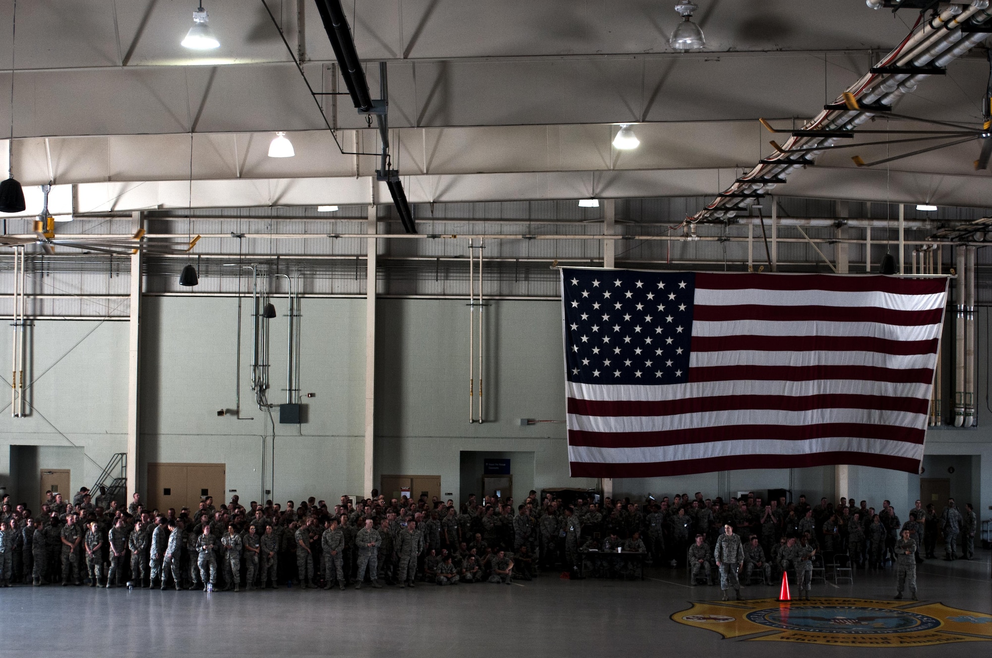 Team Goodfellow members await the next drill demonstration in the High Bay at the Louis F. Garland Fire Academy on Goodfellow Air Force Base, Texas, June 22, 2015. Goodfellow hosts the drill competitions quarterly. (U.S. Air Force photo by Senior Airman Scott Jackson/Released)