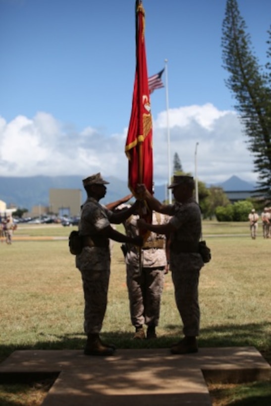 Lt. Col. Robert Maldonado, the commanding officer of Headquarters Battalion, Marine Corps Base Hawaii, relinquishes his command to Lt. Col. Michael Brooks during a change of command ceremony at Dewey Square aboard Marine Corps Base Hawaii, June 22, 2015. Brooks, a South Boston, Va., native, formerly served as the special actions branch chief of the U.S. Central Command Special Actions Branch. (U.S. Marine Corps photo by Cpl. Adam Korolev)