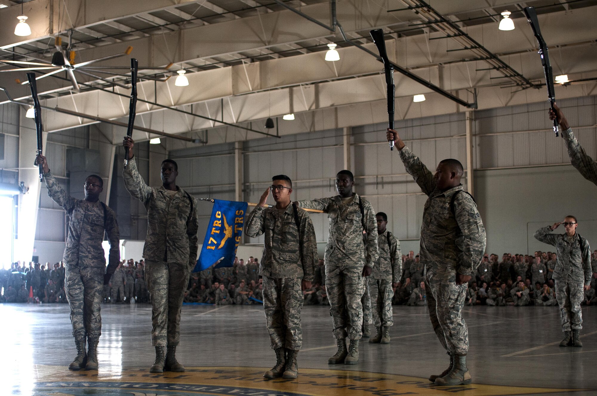 U.S. Air Force Airman 1st Class Matthew R. Ignacio, 316th TRS student and black corps commander, salutes to signify the end of the exhibition drill demonstration in the High Bay at the Louis F. Garland Fire Academy on Goodfellow Air Force Base, Texas, June 22, 2015. Ignacio worked with the other Airman to orchestrate a routine that won first place. (U.S. Air Force photo by Senior Airman Scott Jackson/Released)