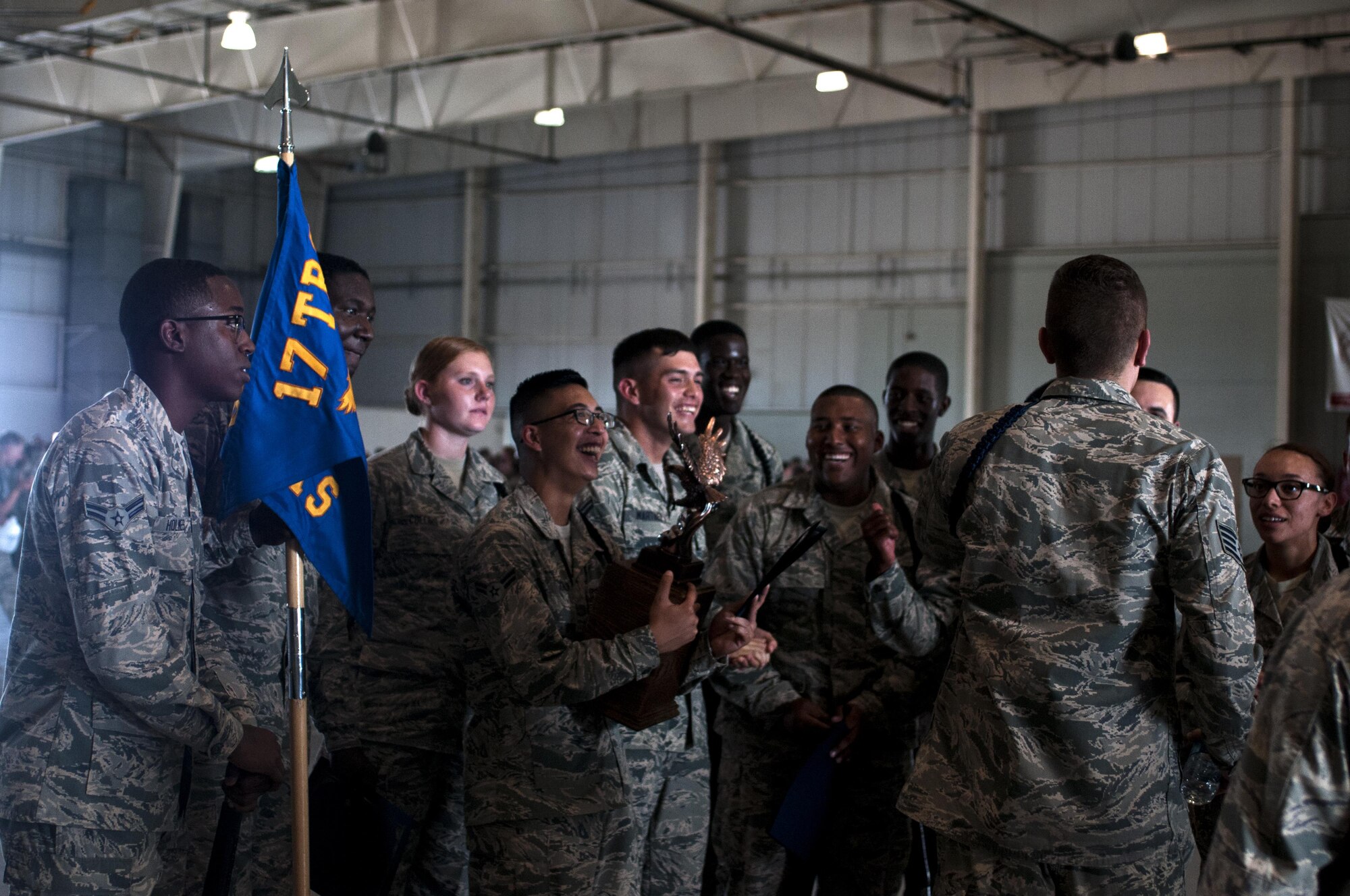 U.S. Air Force Airman of the 316th Training Squadron black rope corps celebrate after winning the drill competition in both the exhibition and regulation drill circuits in the High Bay at the Louis F. Garland Fire Academy on Goodfellow Air Force Base, Texas, June 22, 2015. The 316th TRS competed against both the 315th Training Squadrons and the 312th Training Squadrons. (U.S. Air Force photo by Senior Airman Scott Jackson)