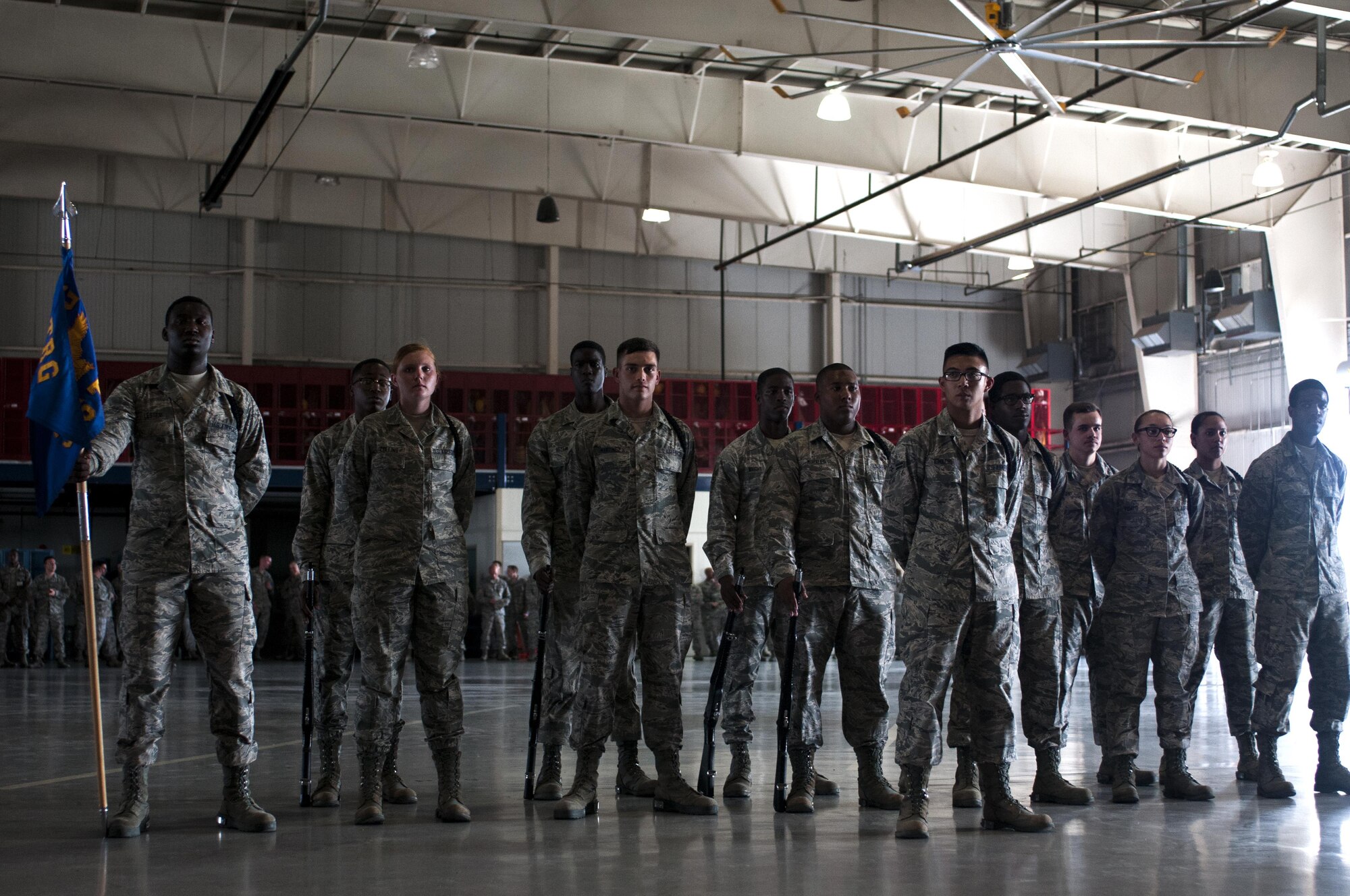 U.S. Air Force Airman of the 316th Training Squadron black rope corps stand in formation during a drill competition in the High Bay at the Louis F. Garland Fire Academy on Goodfellow Air Force Base, Texas, June 22, 2015. Goodfellow hosts the drill competitions quarterly. (U.S. Air Force photo by Senior Airman Scott Jackson/Released)
