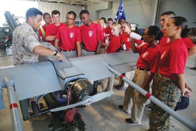 Navy Junior Reserve Officers' Training Corps cadets with the Hawaii Leadership Academy are shown a Shadow RQ-7B unmanned aerial vehicle June 17, 2015, in Hangar 102. The cadets arrived to Marine Corps Base Hawaii on June 13 to build their leadership skills so they could return to their units with billets such as a commanding officer. (U.S. Marine Corps photo by Staff Sgt. Matthew Orr/Released)
