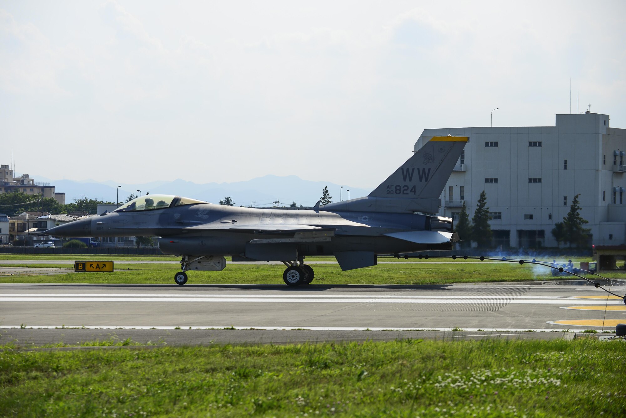 A U.S. Air Force F-16 Fighting Falcon from Misawa Air Base, Japan, connects its J-Hook to an aircraft arresting system at Yokota Air Base, Japan, June 24, 2015. As a pilot lands on a runway during an in-flight emergency, the pilot will drop the J-Hook to the 1.25 inch steel cable of the AAS to assist the jet in rapidly decreasing its speed. (U.S. Air Force photo by Senior Airman David Owsianka/Released)