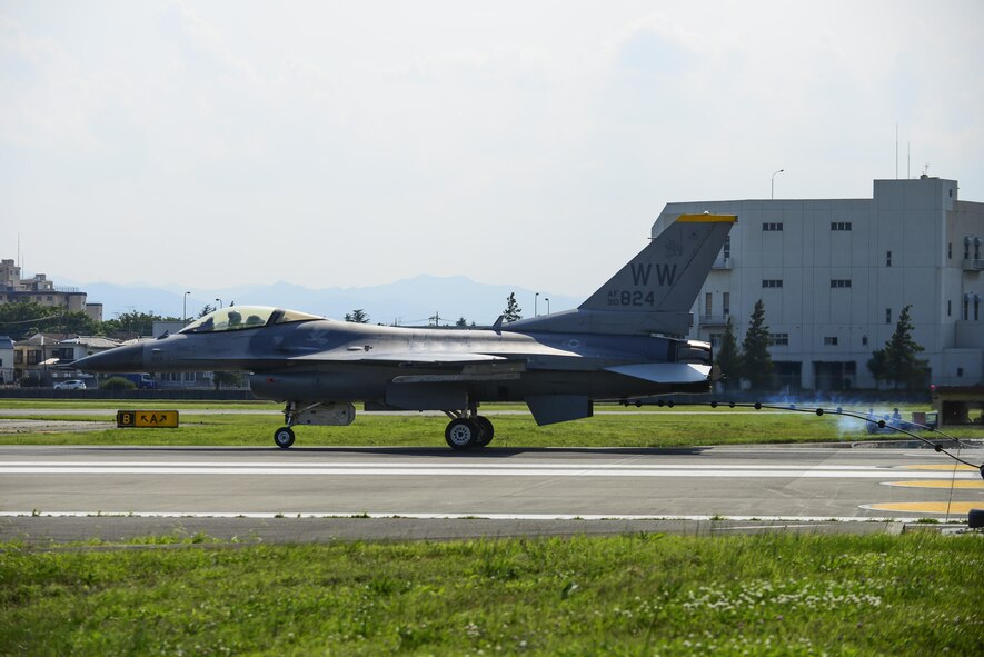 A U.S. Air Force F-16 Fighting Falcon from Misawa Air Base, Japan, connects its J-Hook to an aircraft arresting system at Yokota Air Base, Japan, June 24, 2015. As a pilot lands on a runway during an in-flight emergency, the pilot will drop the J-Hook to the 1.25 inch steel cable of the AAS to assist the jet in rapidly decreasing its speed. (U.S. Air Force photo by Senior Airman David Owsianka/Released)