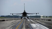 A U.S. Air Force F-16 Fighting Falcon from Misawa Air Base, Japan, slows down on the runway at Yokota Air Base, Japan, June 24, 2015. As the reel of the aircraft arresting system spins it activates a hydraulic pump which compresses a brake pad to safely slow the aircraft. The aircraft can go from a speed of 180 knots to a complete hault in approximately 10 seconds. (U.S. Air Force photo by Senior Airman David Owsianka/Released)