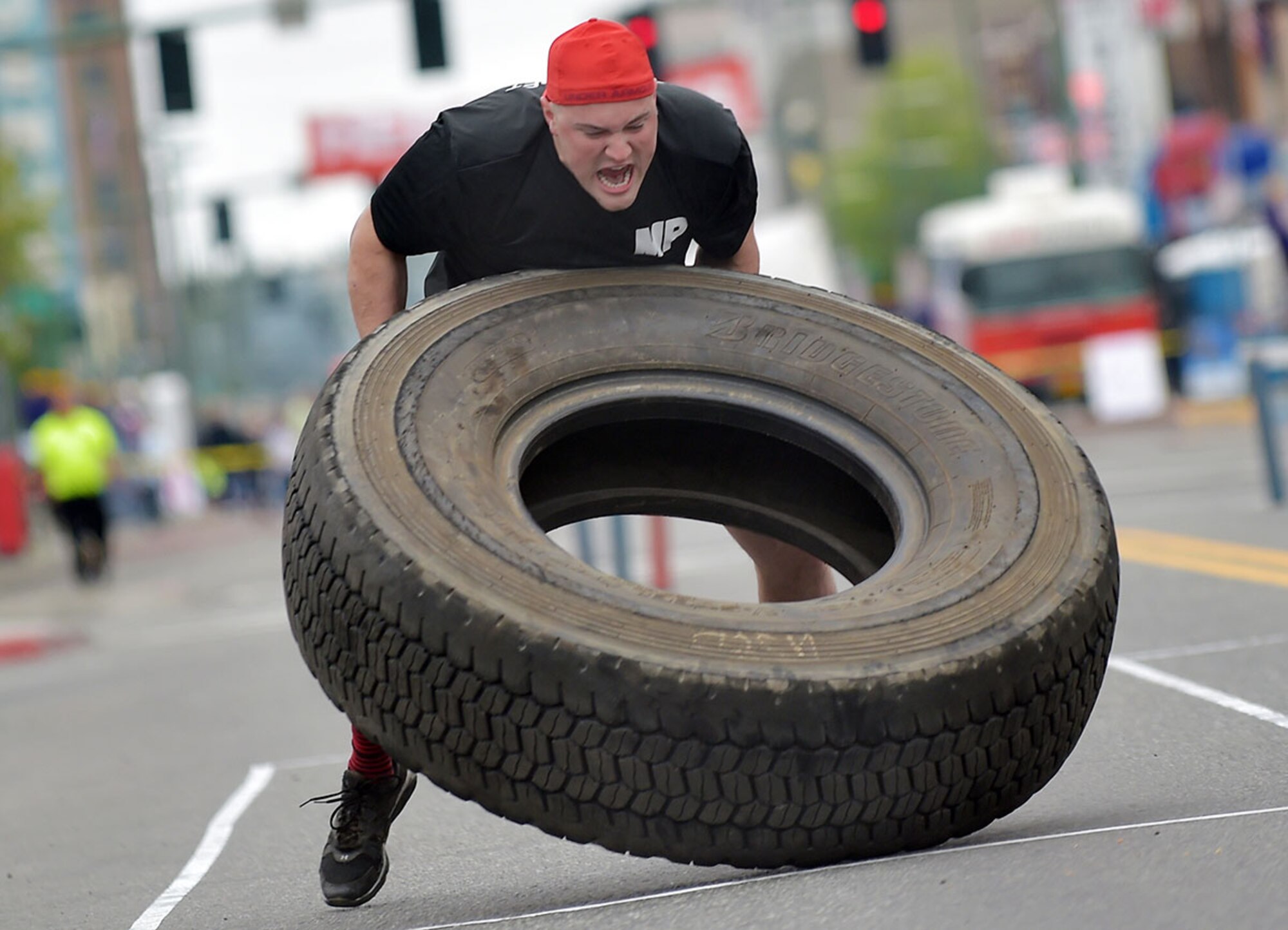 U.S. Army Spc. Jared Schultz, 545th Military Police Company, 6th Brigade Engineer Battalion, 4th Infantry Brigade Combat Team (Airborne), 25th Infantry Division, U.S. Army Alaska, competes in the Hero Games in downtown Anchorage, Alaska, during the Solstice Celebration, June 20, 2015. The annual competition is hosted by the Anchorage Downtown Partnership and pits military members and local civilian firefighter teams against each other in various team-based challenges as part of a larger event celebrating the longest day of the year. (U.S. Air Force photo by Justin Connaher/Released)